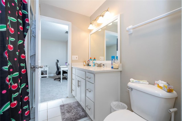 bathroom featuring tile patterned flooring, vanity, and toilet