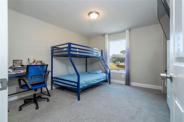 carpeted bedroom featuring a textured ceiling