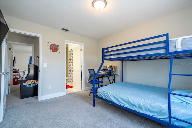 carpeted bedroom with ensuite bath