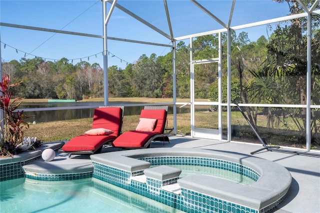 view of swimming pool with a hot tub, a patio, and a lanai