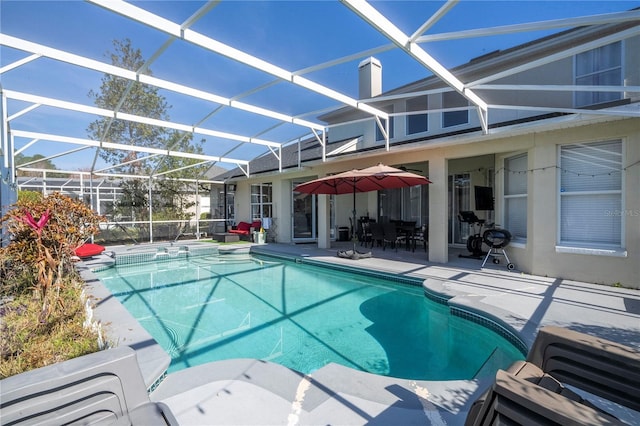 view of pool with a lanai and a patio area