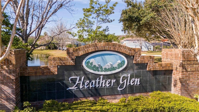 community / neighborhood sign featuring a water view