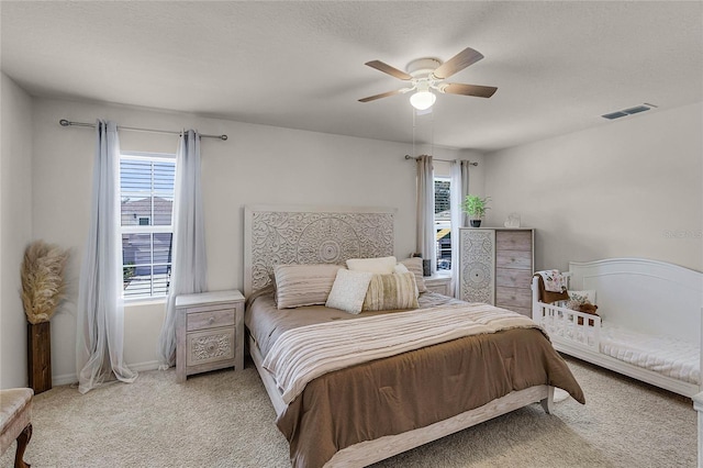 carpeted bedroom with ceiling fan