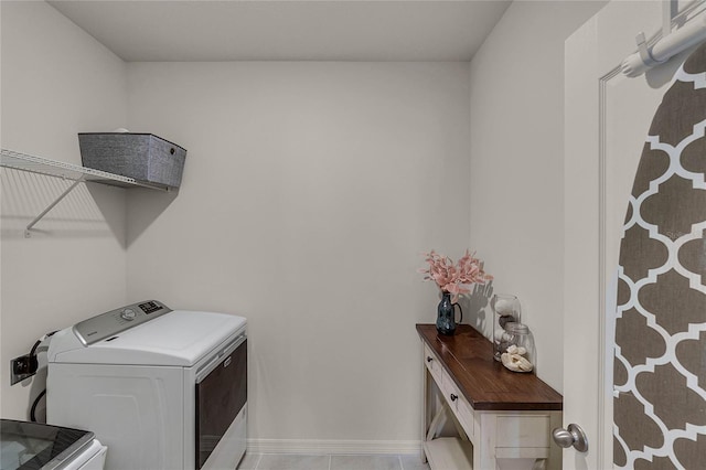 washroom featuring washer and dryer and light tile patterned flooring