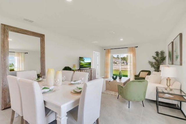 tiled dining room featuring plenty of natural light