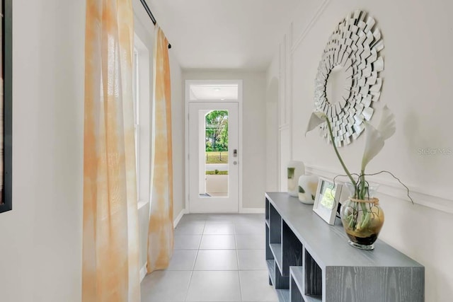 doorway to outside with light tile patterned flooring