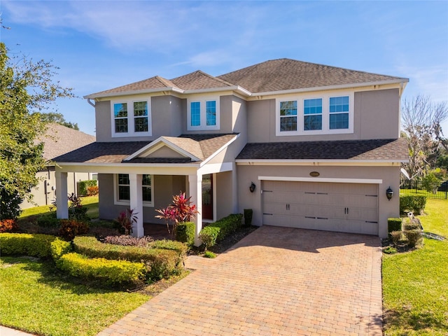 view of front facade featuring a garage and a front lawn