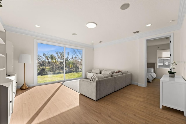 living room featuring wood-type flooring and ornamental molding