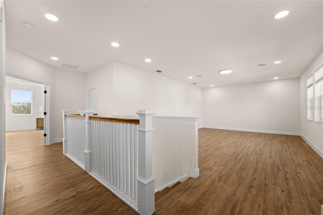 hallway with hardwood / wood-style flooring and a wealth of natural light