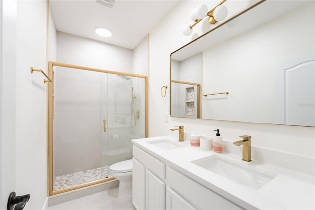 bathroom with vanity, toilet, and a shower with door