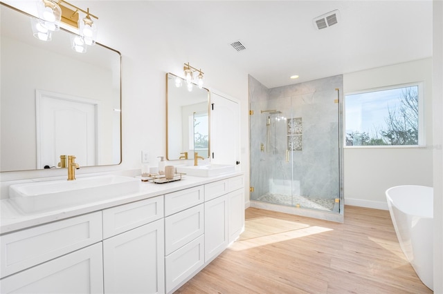 bathroom featuring vanity, hardwood / wood-style floors, and independent shower and bath