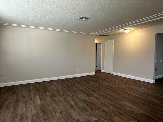 empty room featuring dark hardwood / wood-style flooring and a textured ceiling