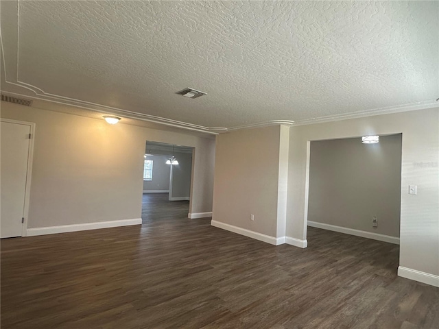 unfurnished room with a textured ceiling and dark hardwood / wood-style flooring