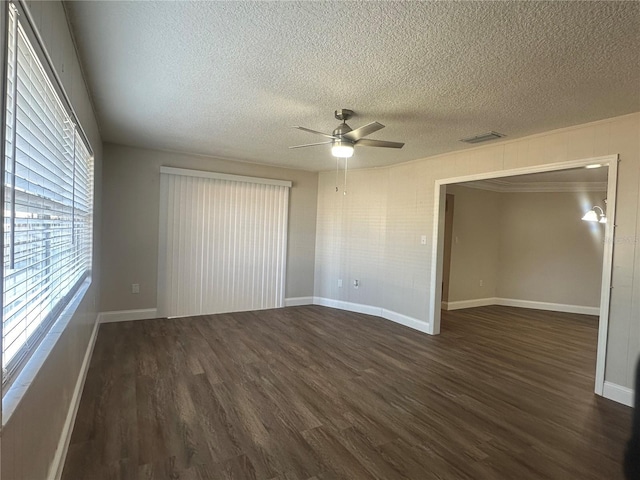 interior space with a textured ceiling, dark hardwood / wood-style floors, and ceiling fan