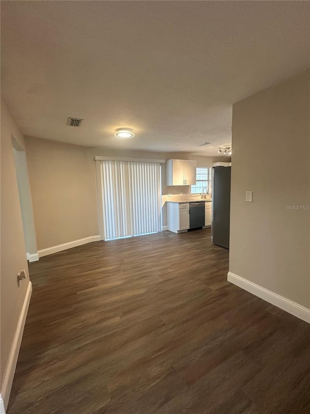 unfurnished living room featuring dark wood-type flooring