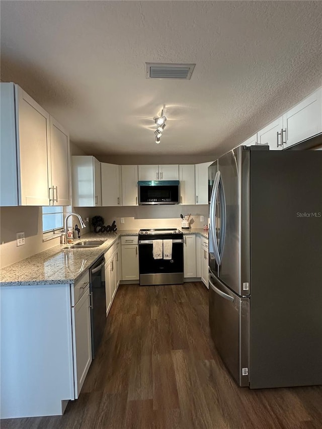 kitchen featuring white cabinetry, stainless steel appliances, and sink