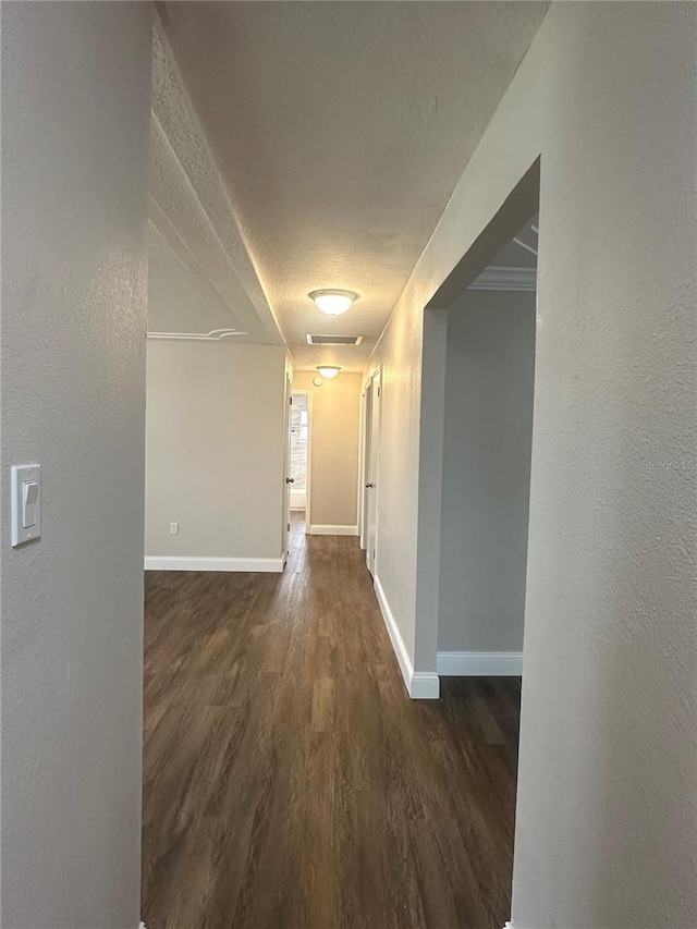 hall featuring dark hardwood / wood-style floors and a textured ceiling