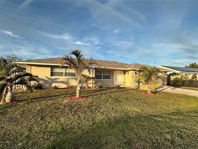 ranch-style house featuring a carport and a front lawn