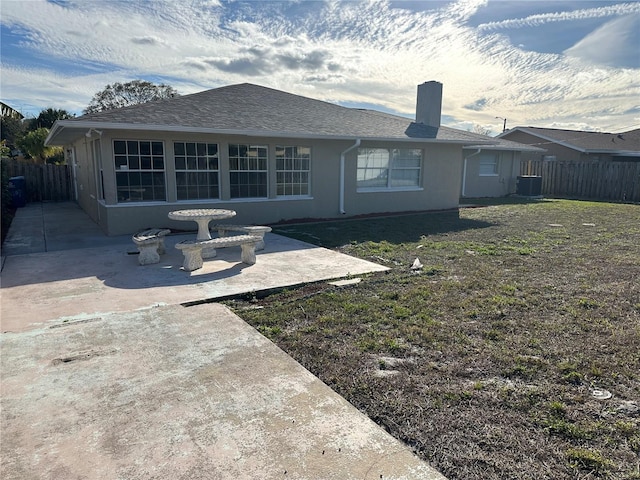 rear view of property featuring a patio and central AC