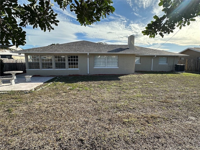 back of house with a lawn, a patio, and central air condition unit