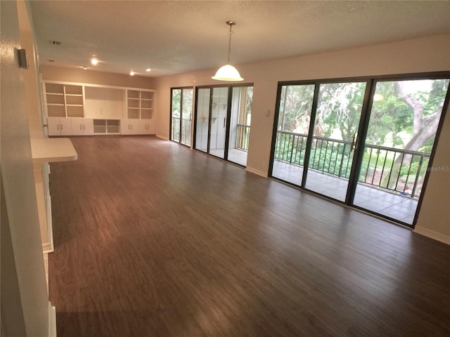 unfurnished living room with dark hardwood / wood-style flooring