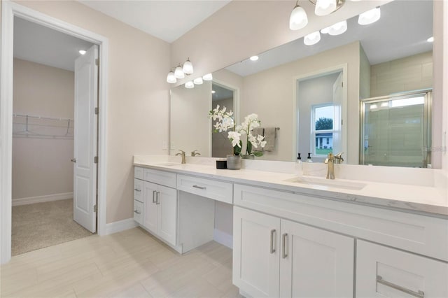 bathroom featuring vanity and a shower with shower door