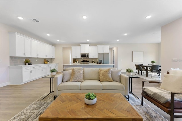 living room with light hardwood / wood-style flooring