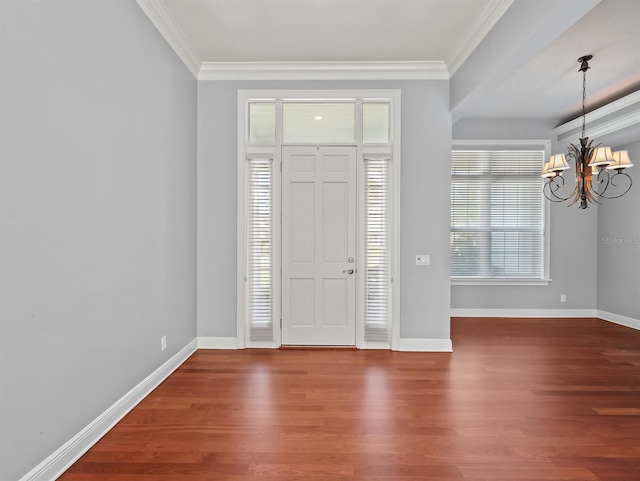 entryway featuring ornamental molding, hardwood / wood-style floors, and a notable chandelier