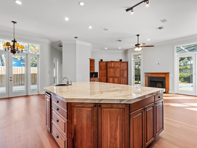 kitchen with a large island, sink, pendant lighting, and a wealth of natural light