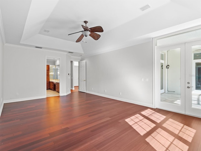 spare room featuring french doors, crown molding, dark hardwood / wood-style floors, a raised ceiling, and ceiling fan