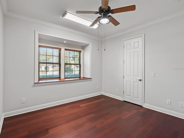 empty room featuring ceiling fan, ornamental molding, and dark hardwood / wood-style floors