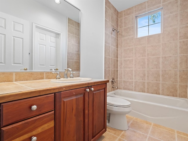 full bathroom featuring tiled shower / bath, toilet, tile patterned floors, and vanity