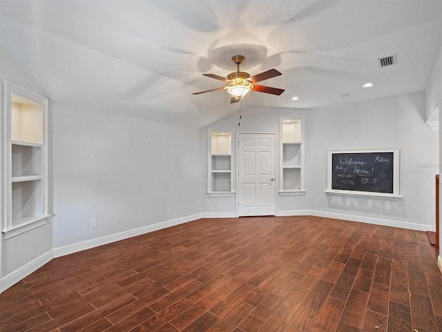 unfurnished living room with vaulted ceiling, dark wood-type flooring, ceiling fan, and built in shelves