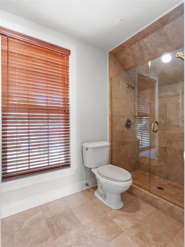 bathroom featuring toilet and an enclosed shower