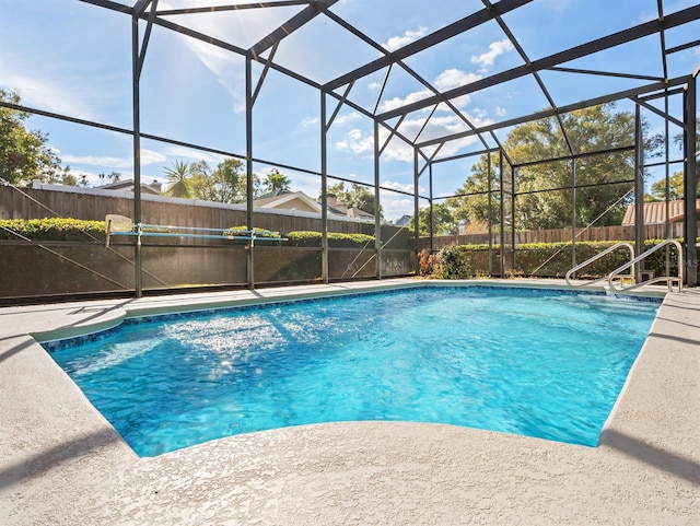 view of pool featuring glass enclosure