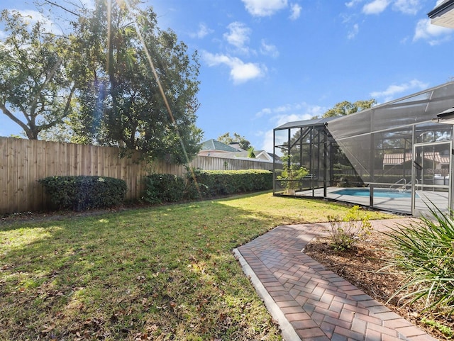 view of yard with a fenced in pool and a lanai