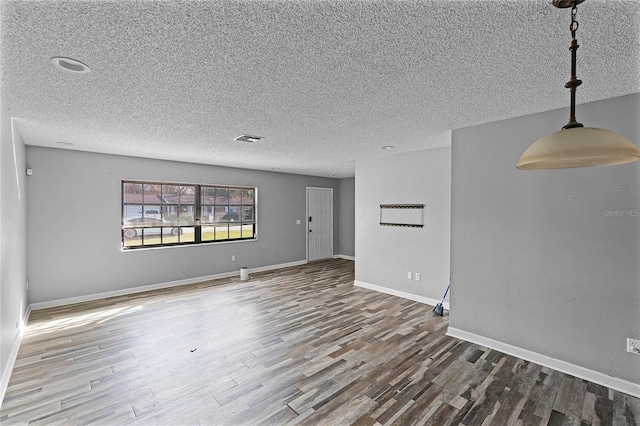 empty room featuring hardwood / wood-style floors and a textured ceiling