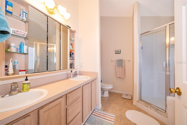 bathroom featuring tile patterned flooring, vanity, toilet, and walk in shower