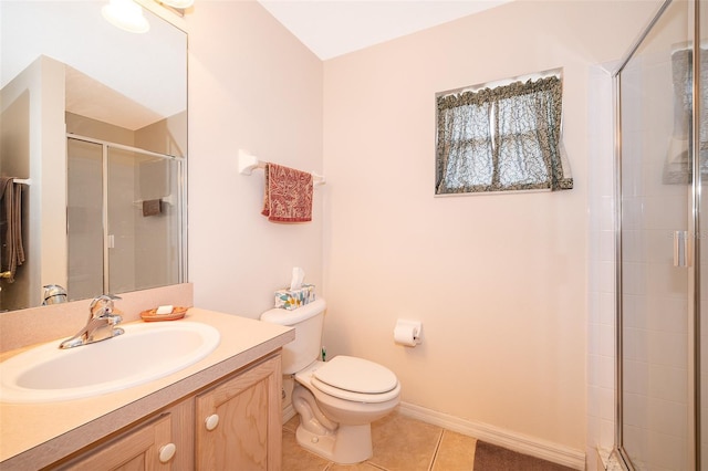 bathroom featuring vanity, a shower with shower door, tile patterned floors, and toilet