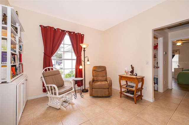 sitting room featuring light tile patterned flooring, ceiling fan, and baseboards