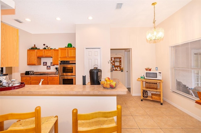 kitchen with visible vents, a chandelier, a peninsula, double oven, and white microwave