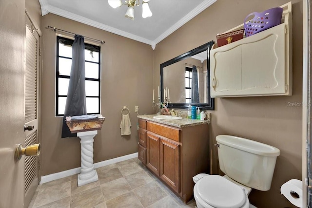 bathroom with ornamental molding, toilet, vanity, and plenty of natural light