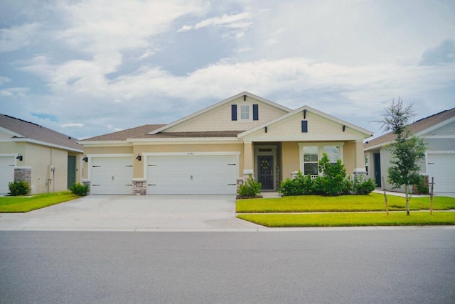 view of front of property with a garage and a front lawn