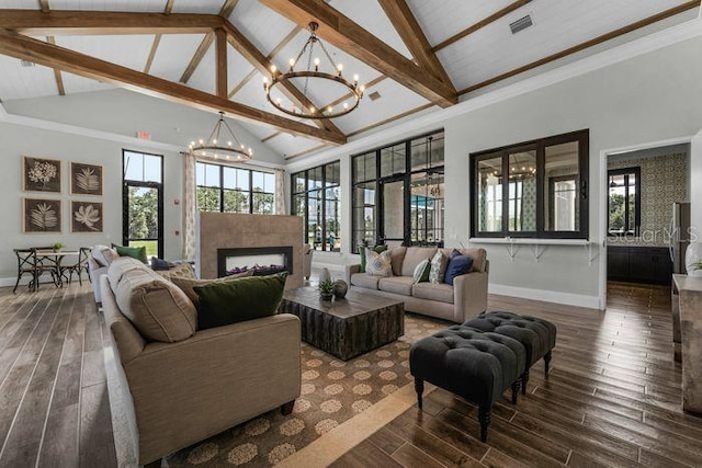 living room featuring plenty of natural light, dark hardwood / wood-style floors, and a chandelier