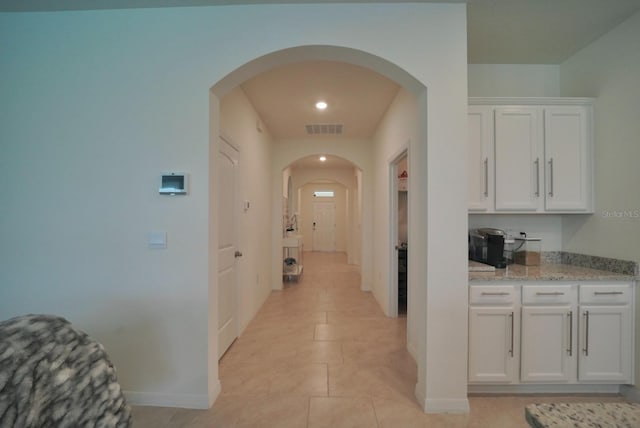 hall featuring light tile patterned floors