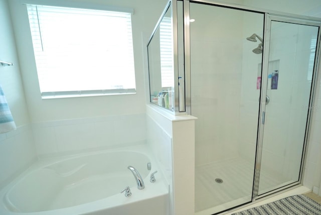 bathroom featuring separate shower and tub