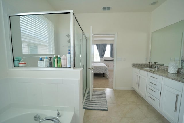 bathroom featuring vanity, a tub to relax in, and tile patterned floors