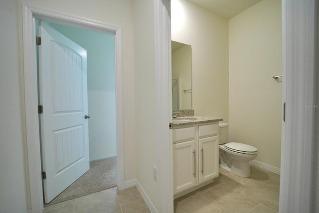 bathroom with vanity, tile patterned floors, and toilet