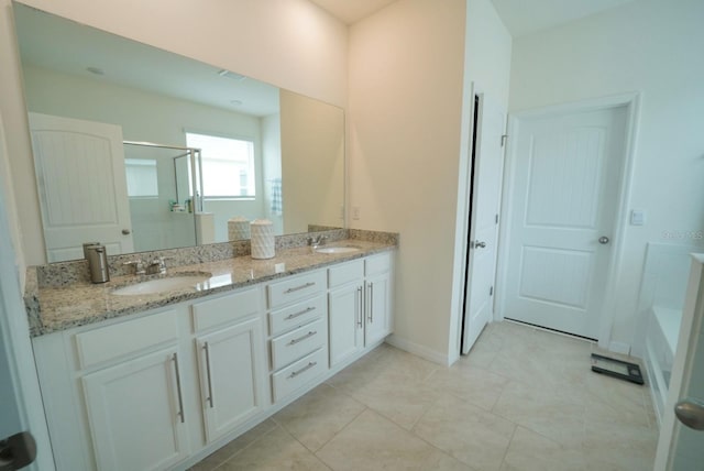 bathroom featuring tile patterned floors, vanity, and a shower with shower door