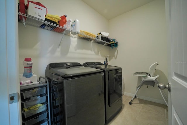 laundry room featuring light tile patterned floors and washer and clothes dryer